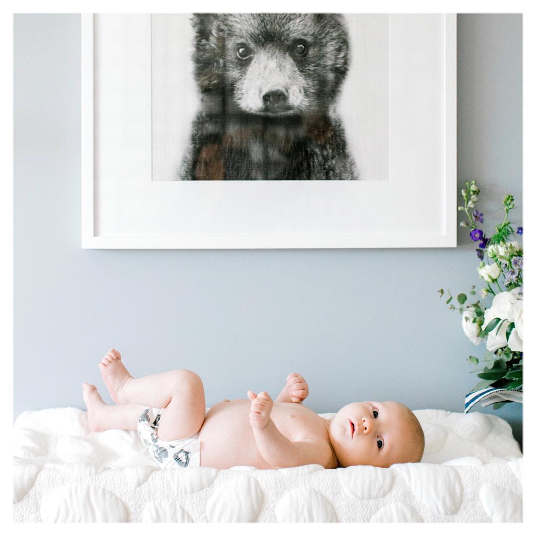 Monochrome nursery wall art featuring baby bear sketch in Posterjack frame above a white dresser.