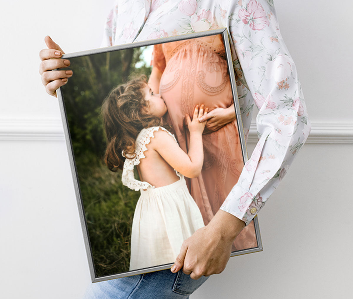 Person holding a canvas print with floater frame