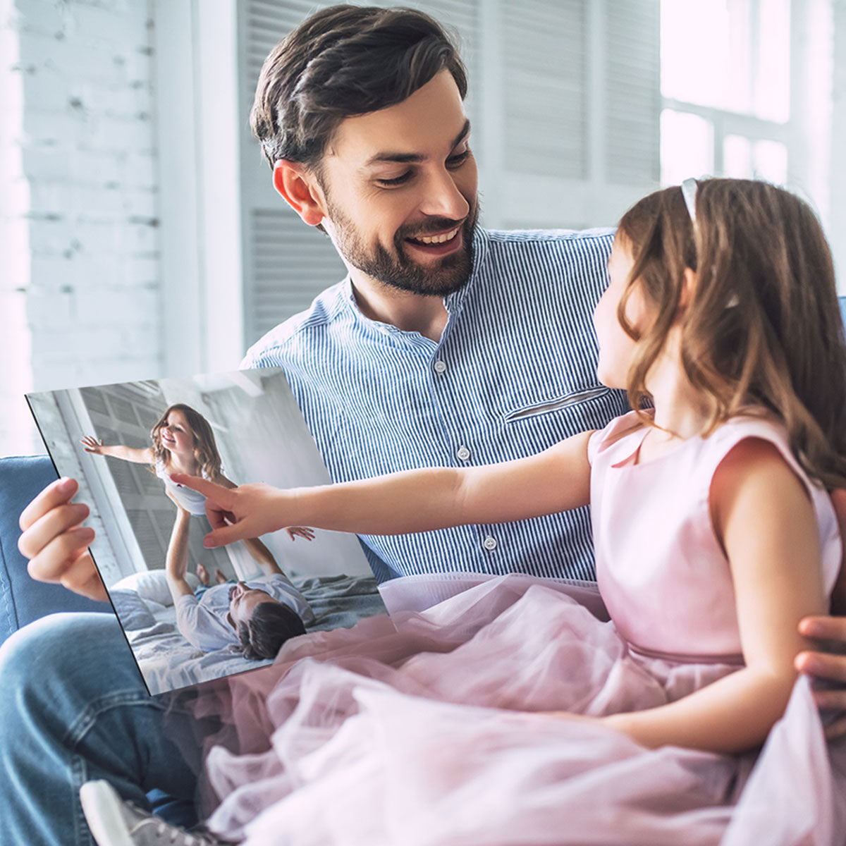 Little girl giving her dad a Father's Day gift