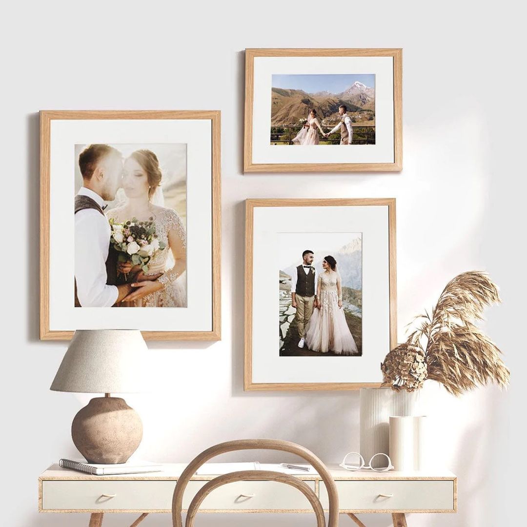 Natural wood picture frames displayed with wedding photos.