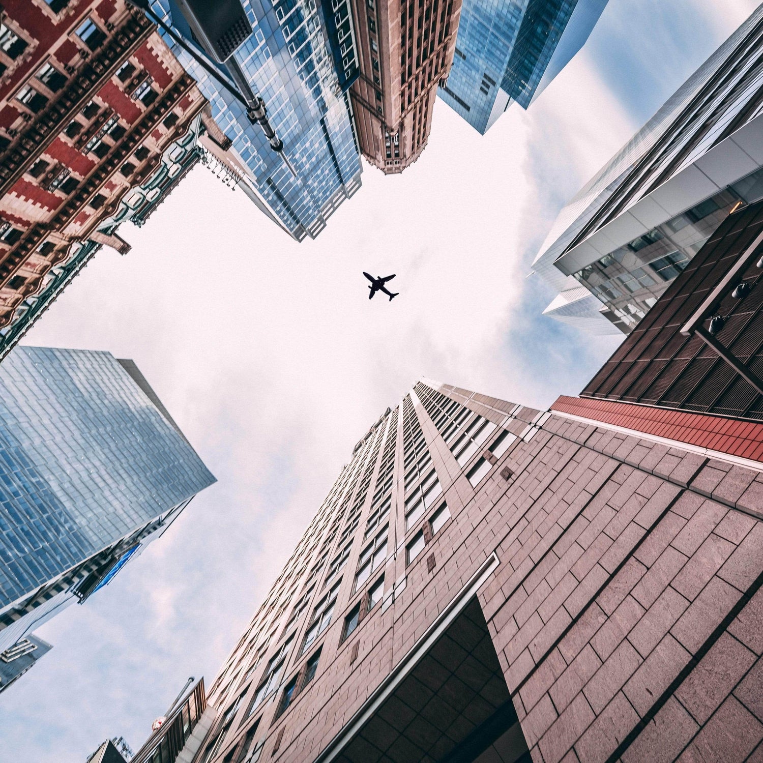 Low-Angle Composition Photo of Airplane and Buildings