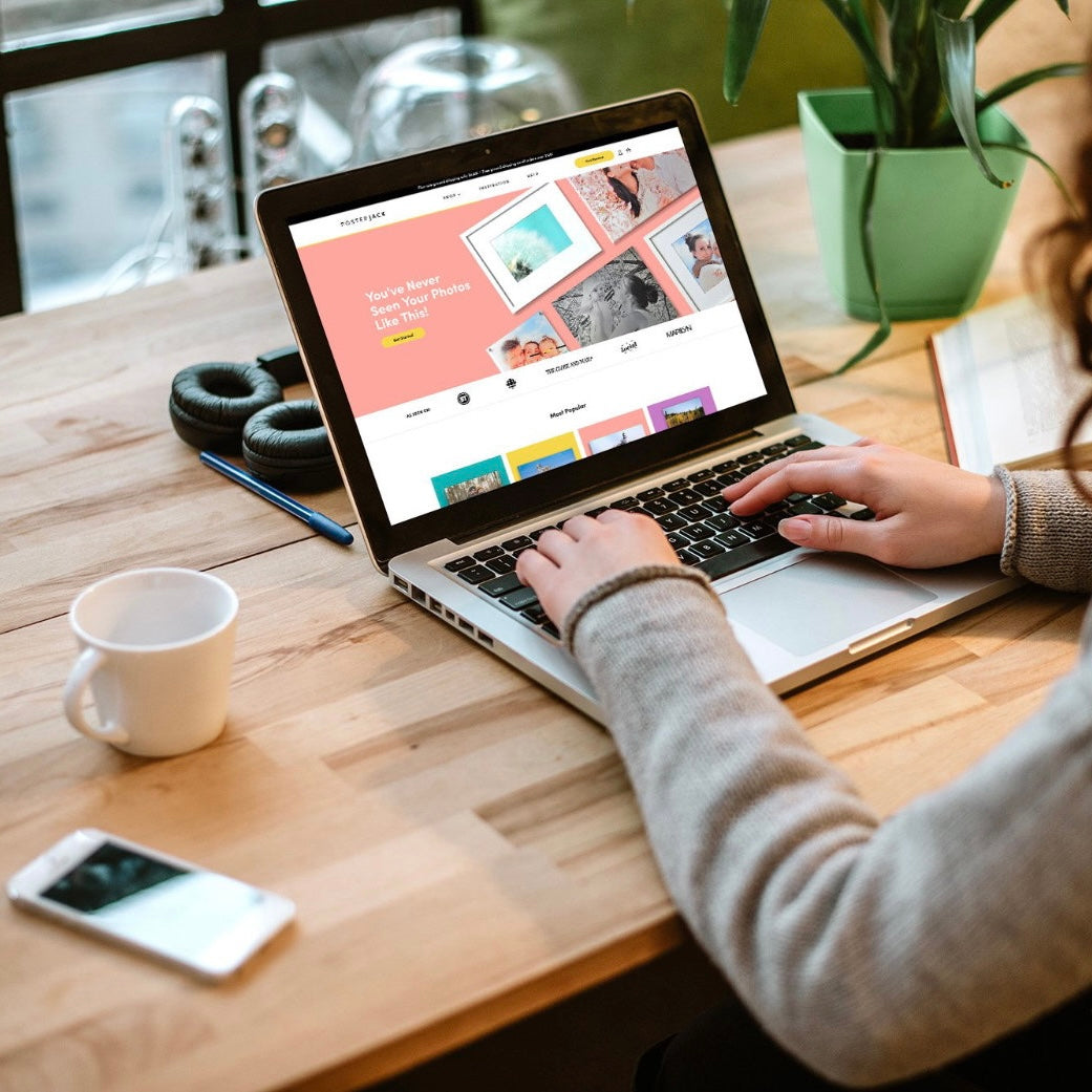 Person on laptop ordering large photo prints from Posterjack Canada