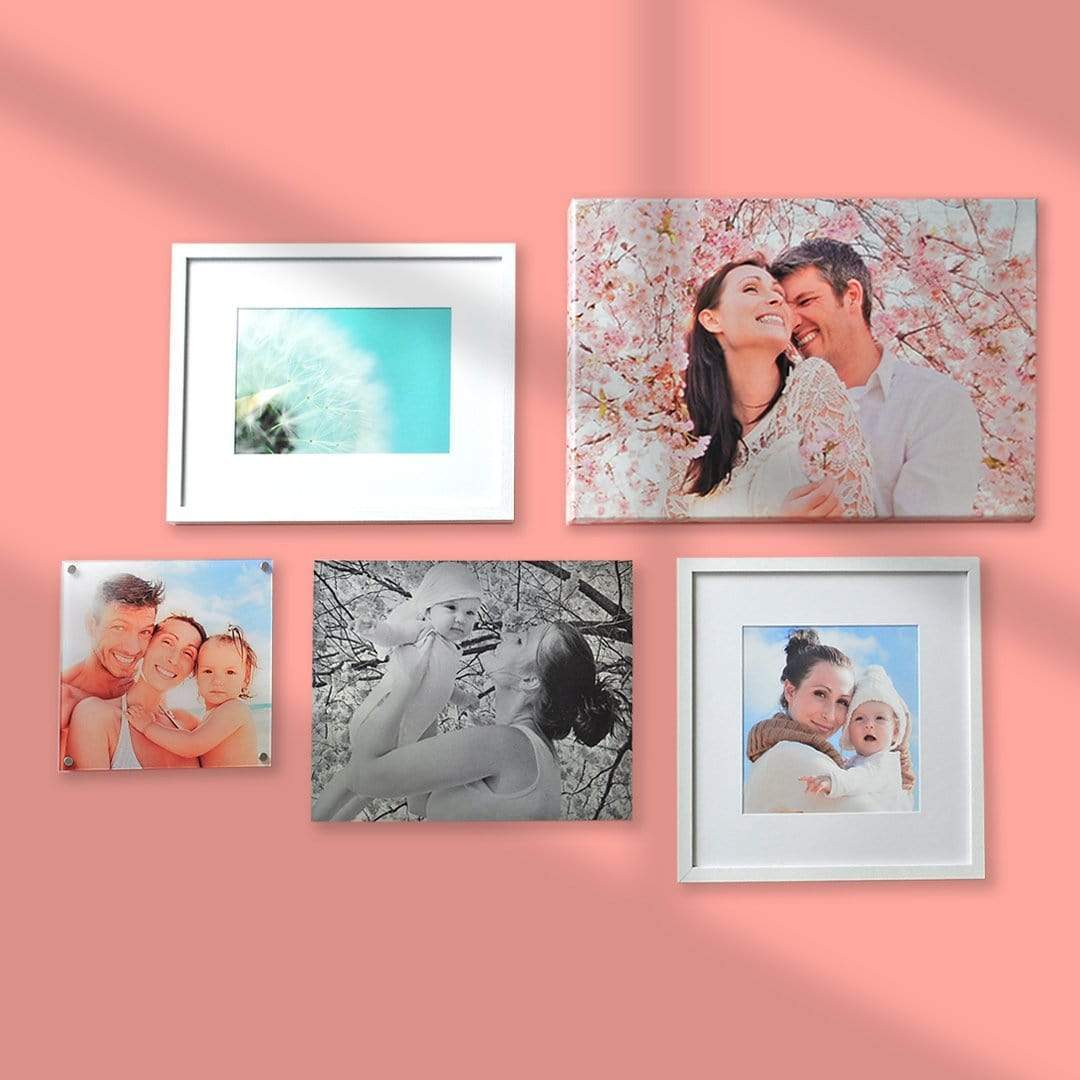 A gallery wall of family photos printed by Posterjack