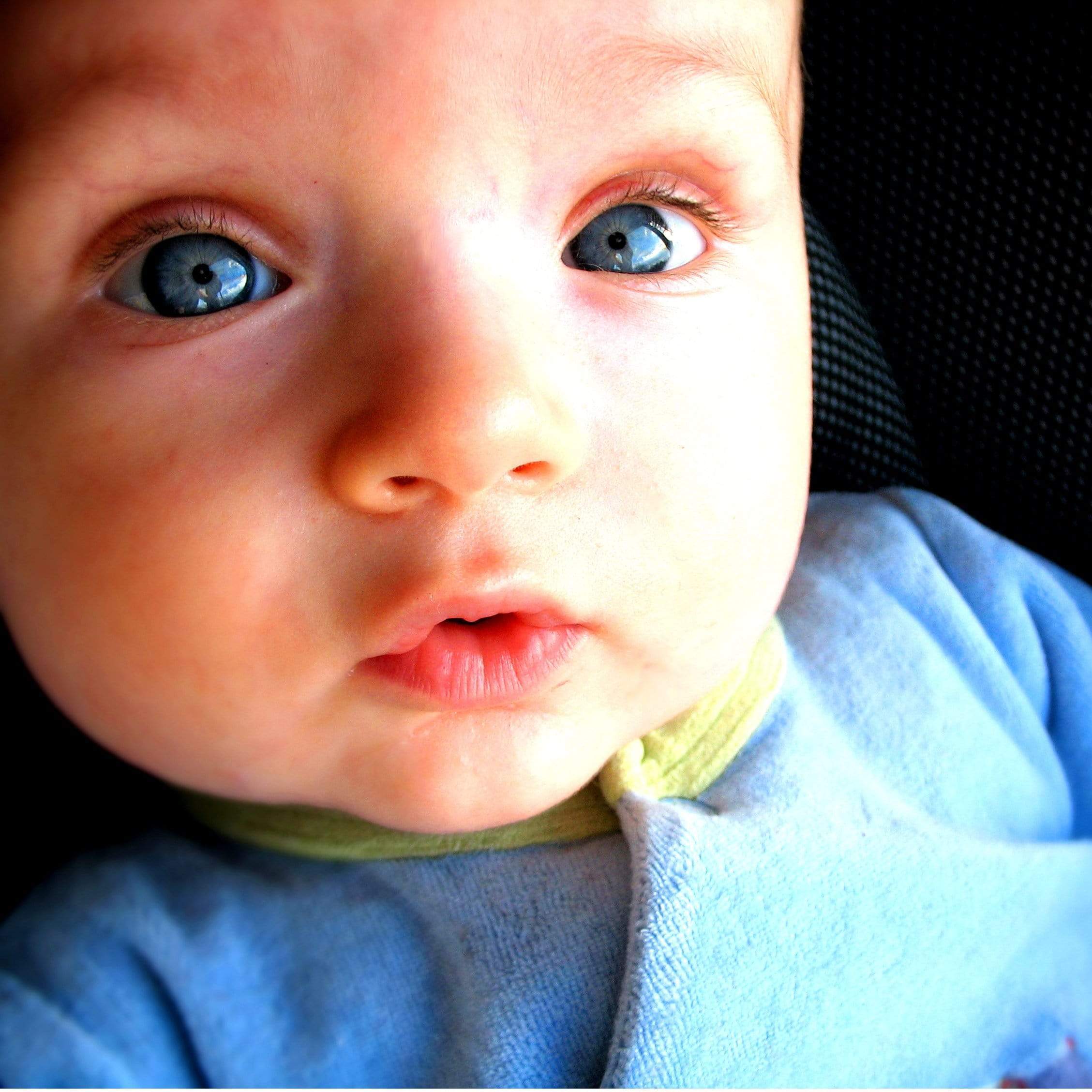 Infant photography close-up of baby boy with blue eyes